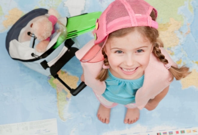 girl-with-luggage-on-map